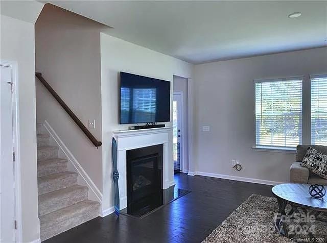 unfurnished living room with dark hardwood / wood-style floors