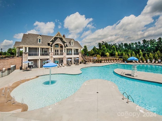 view of pool with a patio and pool water feature