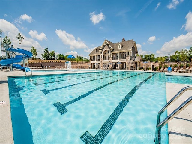 view of swimming pool with a water slide