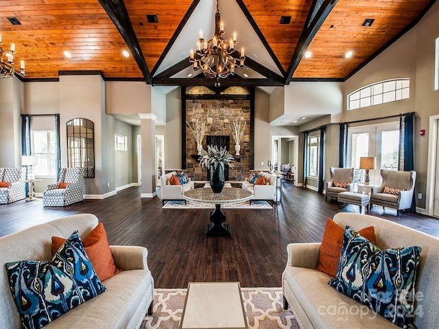 living room with a stone fireplace, wood ceiling, hardwood / wood-style floors, and a healthy amount of sunlight