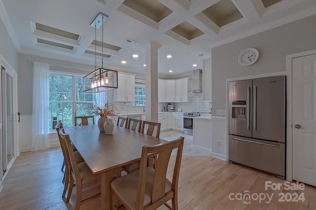 dining space with beam ceiling, coffered ceiling, light wood-type flooring, crown molding, and ornate columns