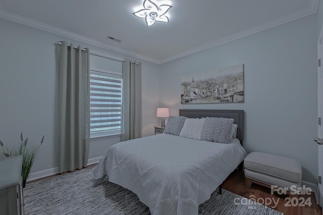 bedroom featuring crown molding and wood-type flooring