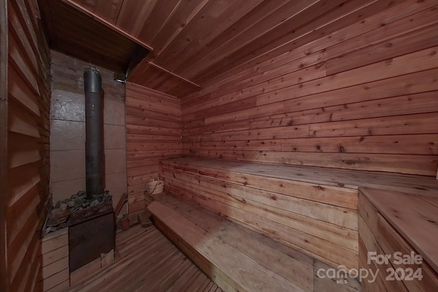 view of sauna with wooden ceiling, wooden walls, and hardwood / wood-style flooring