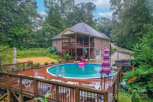 view of swimming pool featuring a patio and a deck