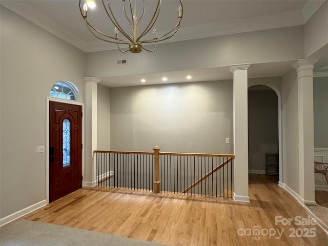 10604 Russet Pl, Charlotte, NC 28227 - foyer entrance with wood finished floors, ornamental molding, a chandelier, arched walkways, and recessed lighting