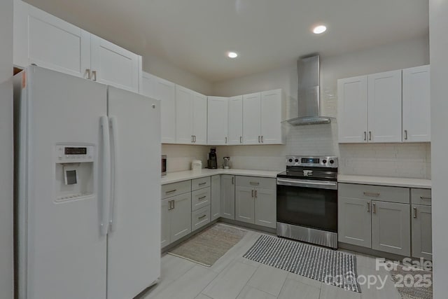 10604 Russet Pl, Charlotte, NC 28227 - kitchen featuring white fridge with ice dispenser, electric stove, wall chimney exhaust hood, gray cabinetry, and recessed lighting