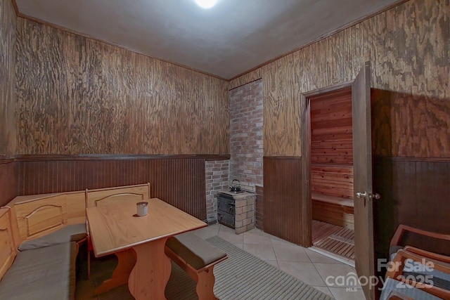 10604 Russet Pl, Charlotte, NC 28227 - dining area featuring light tile patterned floors, wooden walls, and wainscoting