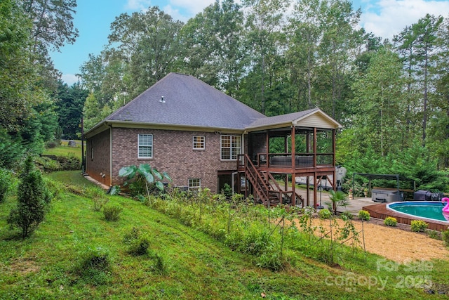 10604 Russet Pl, Charlotte, NC 28227 - back of property featuring a hot tub, a sunroom, stairs, brick siding, and a patio