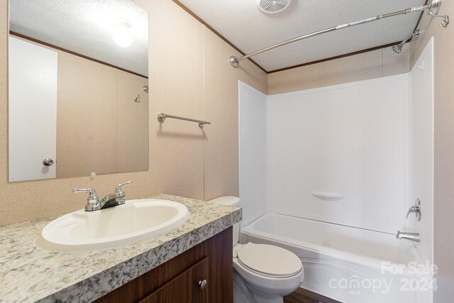 full bathroom featuring a textured ceiling, shower / bathtub combination, vanity, and toilet