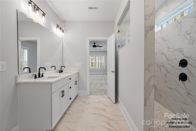 bathroom featuring tiled shower, vanity, a wealth of natural light, and ceiling fan