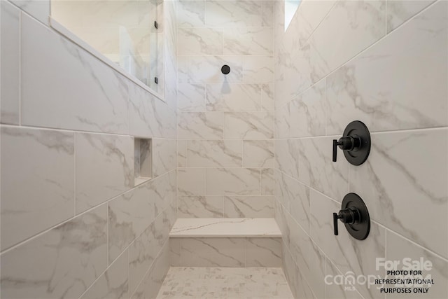 bathroom with tiled shower