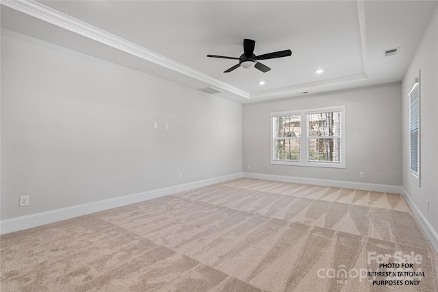 empty room with recessed lighting, visible vents, a tray ceiling, and light colored carpet