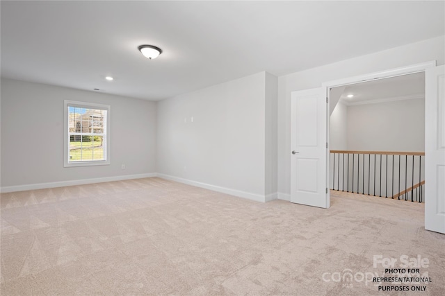 carpeted spare room featuring baseboards and recessed lighting