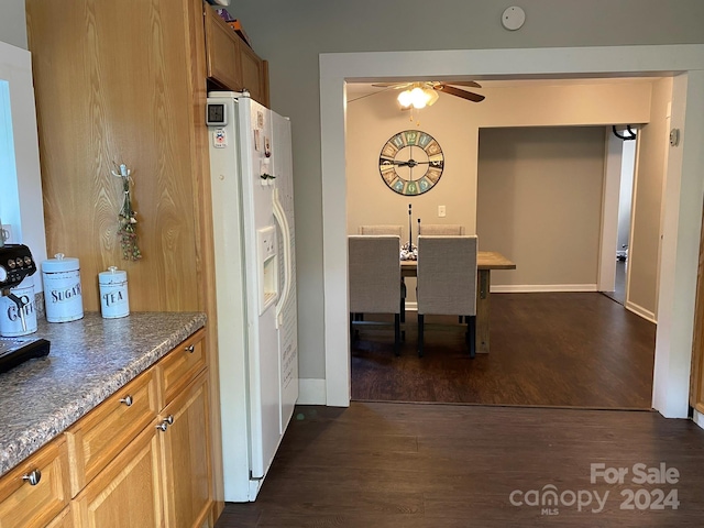 kitchen with white fridge with ice dispenser, dark hardwood / wood-style floors, and ceiling fan