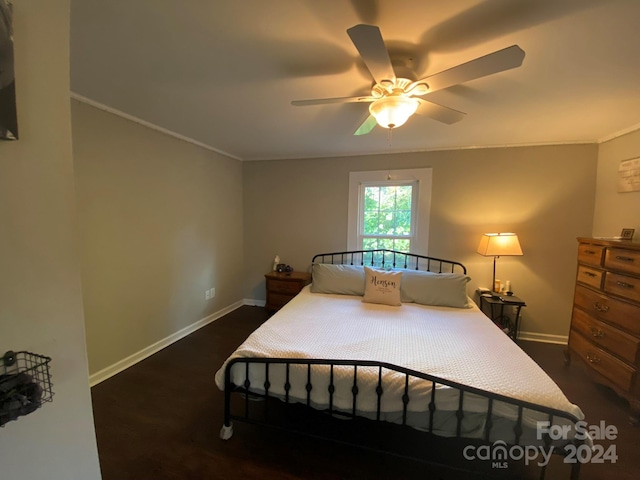 bedroom featuring ornamental molding, ceiling fan, and dark hardwood / wood-style flooring