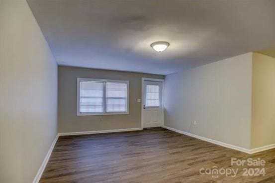 unfurnished room with hardwood / wood-style flooring