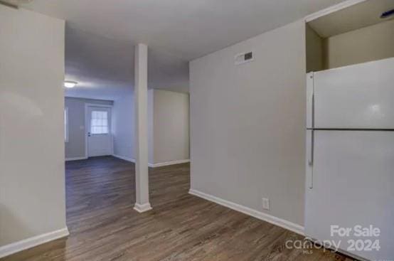 interior space with white fridge and dark hardwood / wood-style flooring