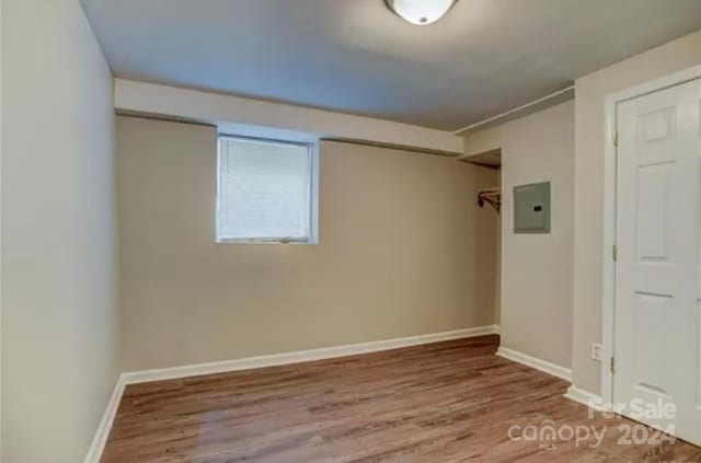 unfurnished room featuring wood-type flooring and electric panel