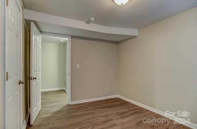 unfurnished room featuring hardwood / wood-style flooring