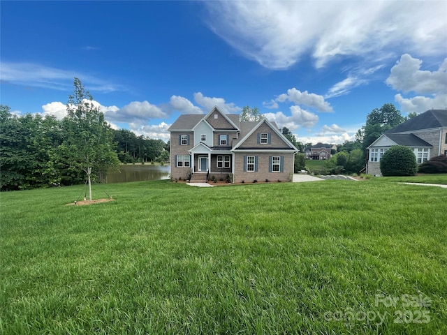 9411 Stonebridge Way Unit 49, Mint Hill, NC 28227 - view of front of house with a front yard, brick siding, and a water view