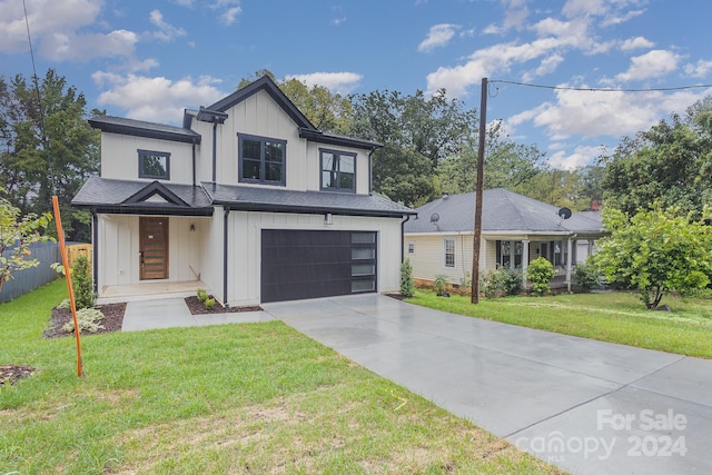 view of front of property featuring a garage and a front lawn