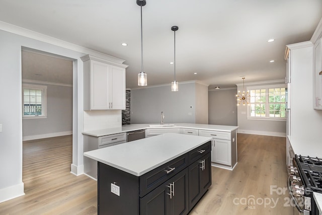 2305 Sanders Ave, Charlotte, NC 28216 - kitchen featuring crown molding, light countertops, a peninsula, stainless steel appliances, and decorative backsplash