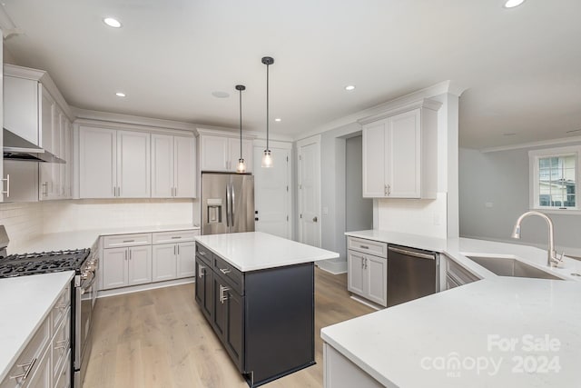 kitchen with pendant lighting, white cabinets, a center island, and appliances with stainless steel finishes