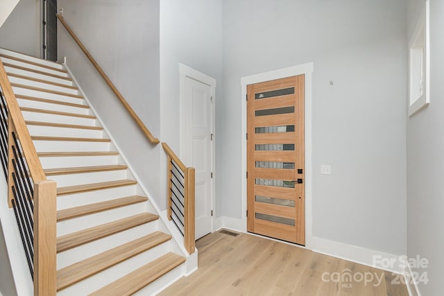 2305 Sanders Ave, Charlotte, NC 28216 - entrance foyer featuring baseboards, a high ceiling, stairway, and light wood finished floors