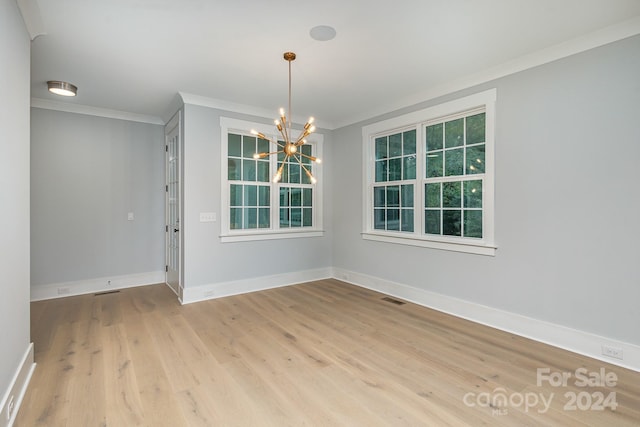 2305 Sanders Ave, Charlotte, NC 28216 - empty room featuring visible vents, a chandelier, baseboards, ornamental molding, and wood finished floors