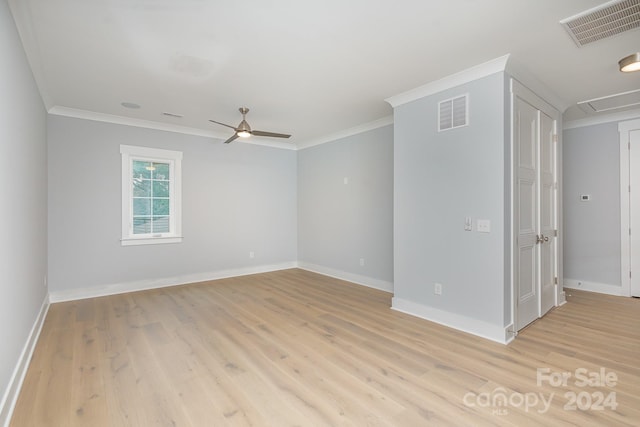 unfurnished room with ceiling fan, light wood-type flooring, and crown molding