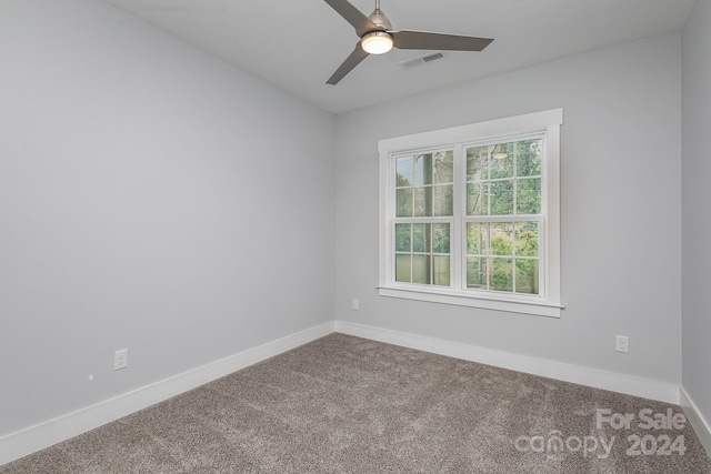 spare room with carpet floors and ceiling fan