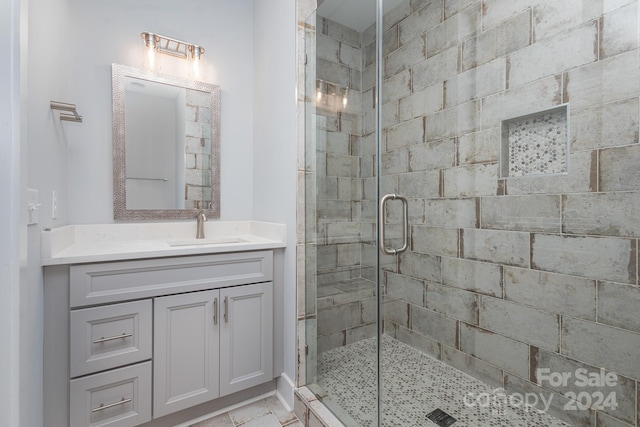 bathroom with walk in shower and vanity