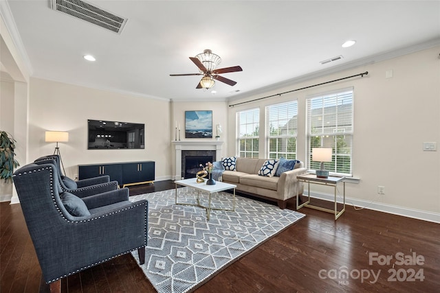 living room with ceiling fan, ornamental molding, and dark hardwood / wood-style flooring