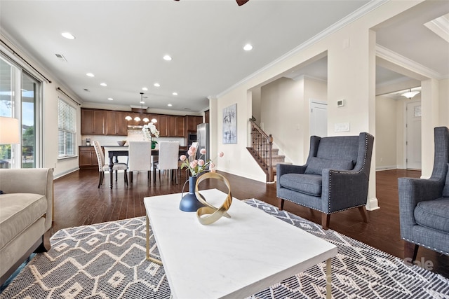 living room with ornamental molding, ceiling fan, and dark hardwood / wood-style flooring