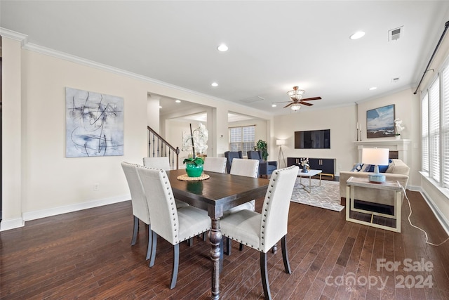 dining room featuring crown molding, dark wood-type flooring, and ceiling fan