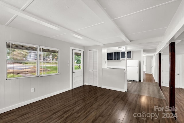 unfurnished living room with dark wood-type flooring