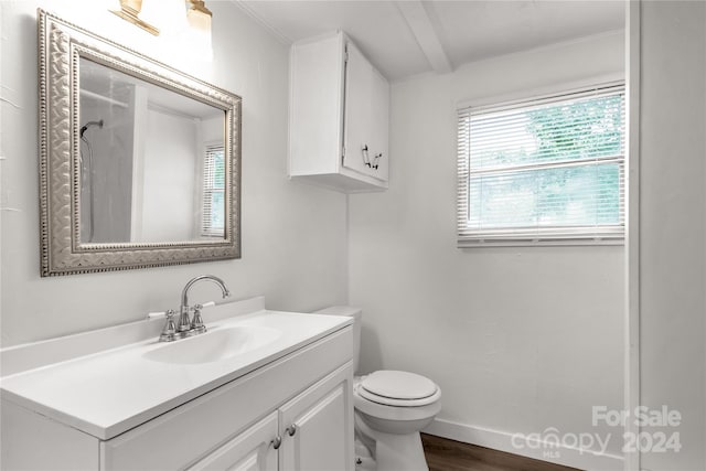 bathroom featuring crown molding, wood-type flooring, vanity, and toilet