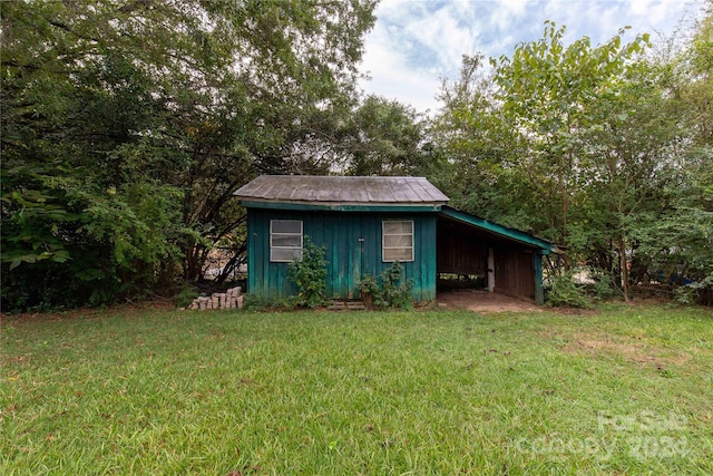 view of outdoor structure featuring a lawn