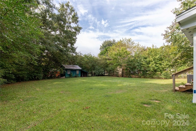 view of yard with a shed and central AC