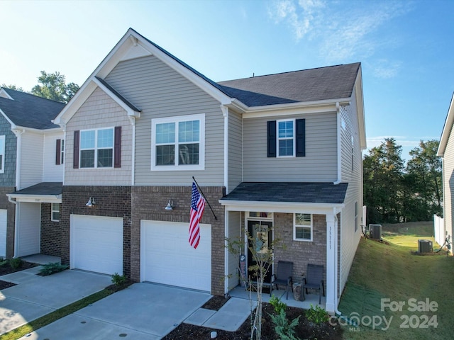 view of front of house featuring central AC and a garage