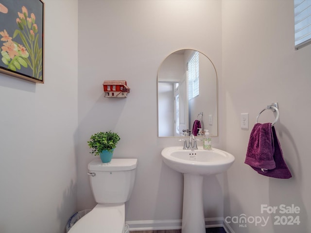 bathroom featuring a healthy amount of sunlight and toilet