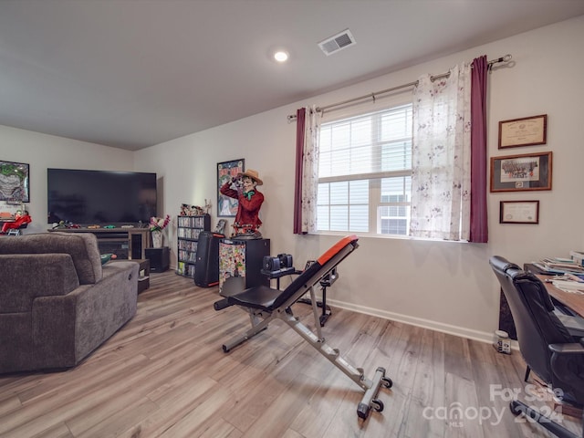 workout area featuring light wood-type flooring