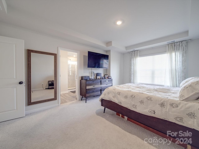 carpeted bedroom with ensuite bathroom