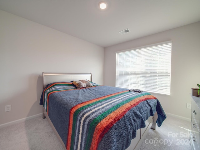 bedroom with light colored carpet