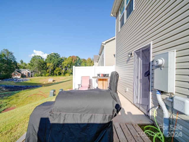 wooden deck featuring a lawn