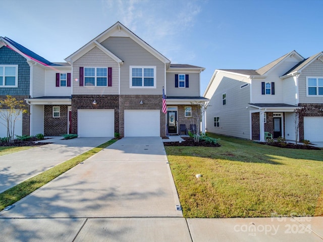 multi unit property featuring a garage and a front lawn