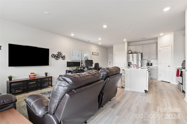 living room with light wood-type flooring and sink