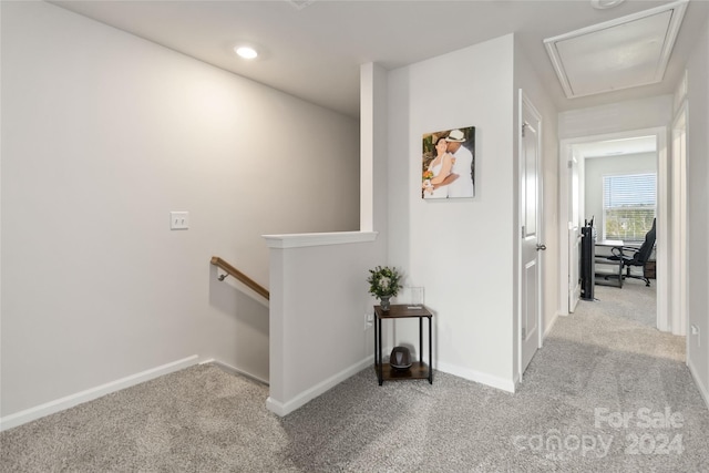 hallway with light colored carpet