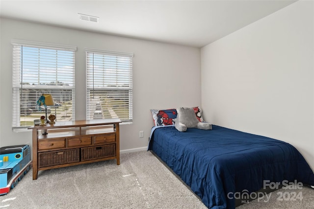 bedroom with light colored carpet