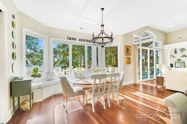 sunroom with a notable chandelier and a healthy amount of sunlight